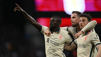 Liverpool's Senegalese striker Sadio Mane celebrates with Jordan Henderson and Diogo Jota. AFP
