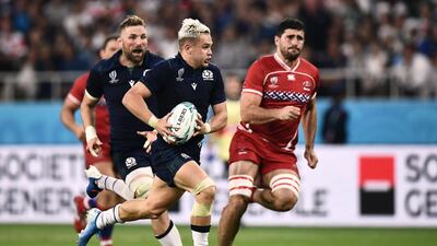 Scotland's wing Darcy Graham (C) runs with the ball prior to a pass leading to a try during the Japan 2019 Rugby World Cup Pool A match between Scotland and Russia at the Shizuoka Stadium Ecopa in Shizuoka. AFP