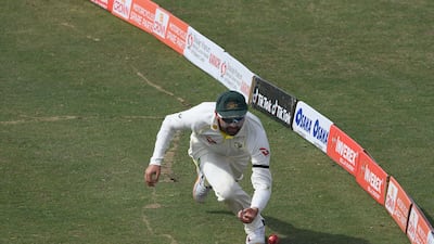 Australia's Nathan Lyon tries to stop a boundary during Day 5. AFP