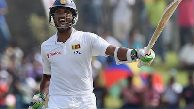 Sri Lanka cricketer Dinesh Chandimal raises his bat on reaching his century on Friday on Day 3 of the first Test against India at Galle. Ishara S Kodikara / AFP / August 14, 2015