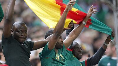 Cameroon supporters celebrate the 2-2 draw against Germany in an international friendly on Sunday. Frank Augstein / AP / June 1, 2014