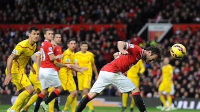 Manchester United's Juan Mata scores their second goal in a 3-0 victory against Liverpool in the Premier League at Old Trafford on Sunday. Peter Powell / EPA