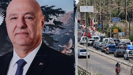 A billboard depicting Lebanese President Joseph Aoun is seen as Lebanese people with their belongings flee along the Sidon highway towards Beirut after Israeli air strikes targeted villages in southern Lebanon in June. EPA