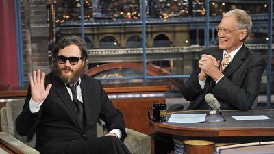 Actor Joaquin Phoenix, waves to the audience during his interview with David Letterman. Getty Images