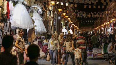 Syrians shop at the Hamidiya market ahead of Eid Al Fitr in the capital Damascus. AFP