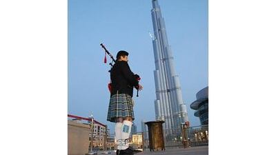 A lone piper plays below the Burj Khalifa in Dubai to commemorate Anzac Day last year.