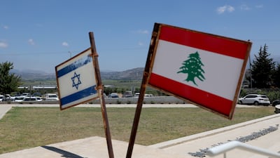 The Israeli and Lebanese flags at a monument called the 'Good Fence', in Metula, Israel. The Lebanese village of Al Khiam can be seen in the background next to the border. EPA
