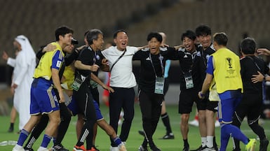 Machida Zelvia coach Go Kuroda, centre (white shirt), celebrates with players and staff members after the AFC Champions League semi-final win over Shabab Al Ahli. Getty Images