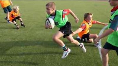 Callum Reid, 11, plays rugby with his school mates at the Al Yasmina School in Khalifa City.
