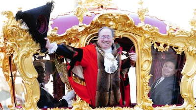 Michael Mainelli, the 695th Lord Mayor of the City of London, waves from the State Coach during the Lord Mayor's Show in the City of London. PA