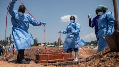 Red Cross and Red Crescent members lower the coffin of a baby who died of Ebola at an orphanage in Bunia, at Mbiyo cemetery in Ituri Province, Democratic Republic of Congo. AFP