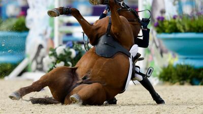 Hwang Woojin, of South Korea, and his horse Shearwater Oscar, fall down after the horse bucked after the starting bell. Markus Schreiber/AP Photo