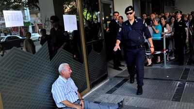 An elderly man cries outside a bank as pensioners queue to get their pensions in the Greek city of Thessaloniki on July 3, 2015. Sakis Mitrolidis / AFP