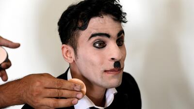 Karim Asir has his make-up applied before a performance in Kabul. Reuters