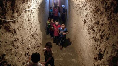 Syrian children play in the underground playground built to protect them from shelling. More than 280,000 people have been killed and millions have been displaces since Syria’s conflict broke out in March 2011.