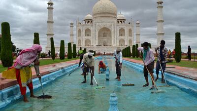 Workers clean a water fountain tank at the Taj Mahal in Agra, one of India's biggest tourist attractions. AFP