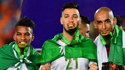 Hicham Boudaoui, Ramy Bensebaini and goalkeeper Azzedine Doukha celebrate Algeria's success. AFP