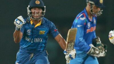 Kumar Sangakkara celebrates in the final over as MS Dhoni of India, right, looks on during the final of the ICC World Twenty20 Bangladesh 2014 between India and Sri Lanka at Sher-e-Bangla Mirpur Stadium on April 4, 2014 in Dhaka, Bangladesh. Sangakkara's half century helped Sri Lanka win by six wickets to break their spell of bad luck in finals. Scott Barbour / Getty Images