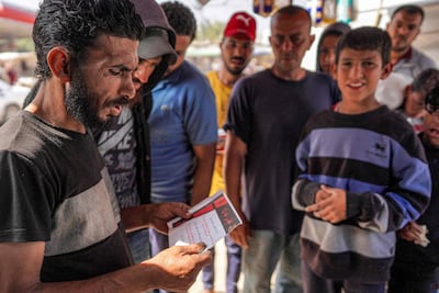 A man reads a leaflet dropped by the Israeli army that designates the Wadi Gaza area as a ‘dangerous combat zone’. AFP