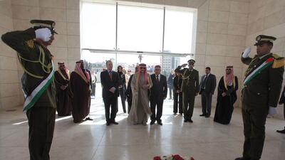 Saudi Prince Al Waleed Bin Talal visits the grave of former Palestinian leader Yasser Arafat during an official visit to the West Bank city of Ramallah on March 4, 2014. The billionaire is in the Israeli-occupied West Bank for a meeting with Palestinian president Mahmud Abbas. Abbas Momani / AFP photo