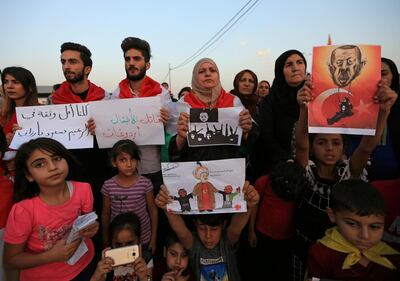 Syrian refugees protest the Turkish offensive against Syria during a demonstration at the Domiz refugee camp on the outskirts of Dohuk, Iraq October 12, 2019. REUTERS/Ari Jalal