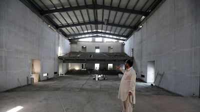 Asad Khan, office manager of the Pakistan Association Dubai, surveys progress at the community centre building. Although a shortfall remains, the association is confident the hall will open early next year. Pawan Singh / The National