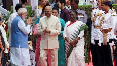 India's Prime Minister Narendra Modi, left, greets President Droupadi Murmu, third from left, and her predecessor Ram Nath Kovind, centre, in New Delhi. Reuters