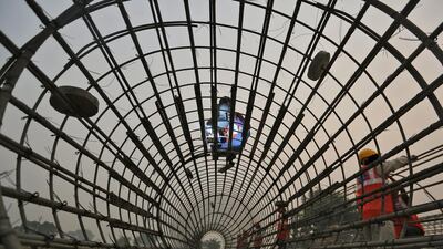 Labourers work at the construction site of a bridge being built for metro rail in New Delhi. Anindito Mukherjee / Reuters