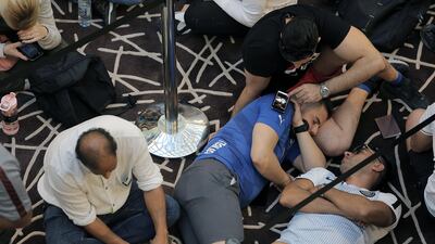 Customers wait outside the Apple store at Dubai Mall. Mahmoud Khaled / EPA