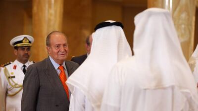 King Juan Carlos, second from left, welcomed by UAE officials at the Emirates Palace hotel. Ali Haider / EPA