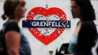 Messages of condolence for the 72 victims of the Grenfell Tower fire, near to the shell of the London tower block. Daniel Leal-Olivas / AFP