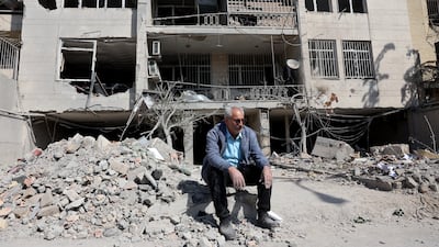 An Iranian man sits next to the remains of his building in Tehran on Wednesday. Attacks on the Gulf only amplify the message that Tehran’s leaders are reckless and willing to risk the lives and livelihoods of the Iranian people. EPA