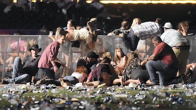 People scramble for cover at the Route 91 Harvest country music festival after gunfire was heard on October 1, 2017 in Las Vegas, Nevada. David Becker / Getty Images