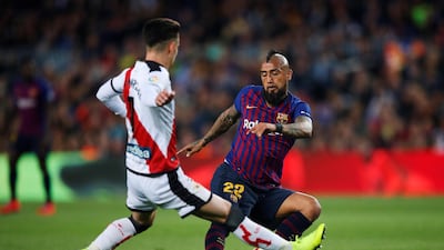 Barcelona's Arturo Vidal vies for the ball with Rayo Vallecano's Alex Moreno. EPA