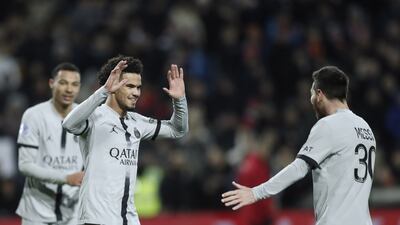 Paris Saint Germain teenager Warren Zaire-Emery , centre, celebrates with teammate Lionel Messi after scoring the third goal. EPA
