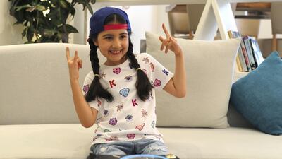 Michelle Rasul flashes a rockstar sign in the lobby of her apartment building in Dubai. AP Photo