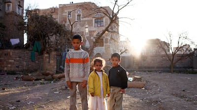 Hamad with younger siblings Noura, six, and Mohamed, seven, on disused land behind their home in the old city of Sanaa
