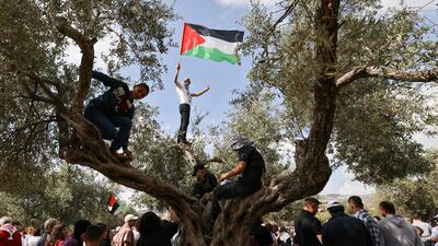 An Arab Israeli with a Palestinian national flag during a demonstration near the city of Sakhnin in northern Israel. On May 15 Palestinians will mark the 74th anniversary of the Nakba, the 'catastrophe' of Israel's creation in 1948. AFP
