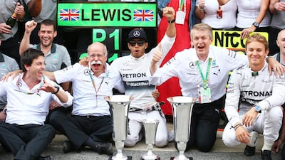 Lewis Hamilton, centre, of Mercedes GP celebrates his victory with teammate Nico Rosberg, right, Mercedes GP executive director Toto Wolff, left, and the rest of the team after the Spanish Formula One Grand Prix at Circuit de Catalunya on May 11, 2014 in Montmelo, Spain. Mark Thompson/Getty Images