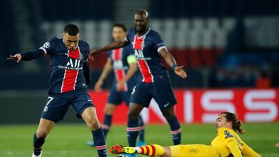 PSG's Kylian Mbappe, left, fights for the ball with Barcelona's Antoine Griezmann during the Champions League, round of 16, second leg soccer match between Paris Saint-Germain and FC Barcelona. AP
