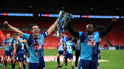 Wycombe Wanderers' Matt Bloomfield (left) and Adebayo Akinfenwa celebrate with the trophy. PA
