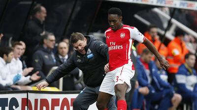 Newcastle United manager John Carver tries to get the ball from Arsenal's Danny Welbeck on Saturday in the Premier League. Andrew Yates / Reuters