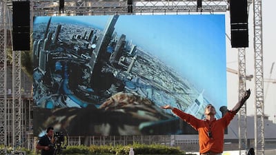 Darshan the eagle flies around the Burj Khalifa - the camera on his back transmitting images to a video screen - as Jacques-Olivier Travers, the bird's trainer, guides him to earth. Jeffrey E Biteng / The National