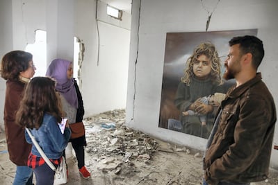 Palestinian artist Ali al-Jabali walks people through his haunting exhibit. Courtesy Fady Hanona