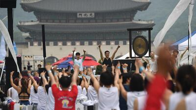Participants take part in a mass yoga event at Gwanghwamun Square in Seoul. Jung Yeon-je / AFP