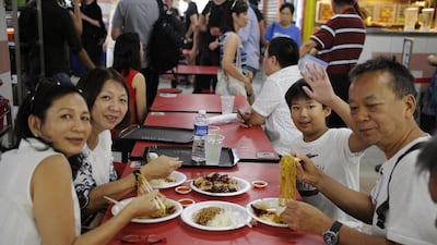 A family from Malaysia enjoying Chan’s Michelin-starred soya sauce chicken.