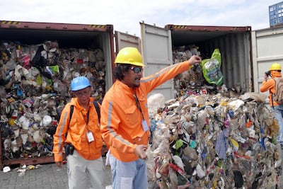 Philippine customs officials inspect cargo containers containing tonnes of garbage shipped by Canada at Manila port November 10, 2014. REUTERS
