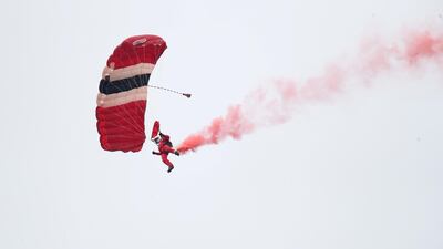 A member of The Red Devils parachute display team before the match. Reuters