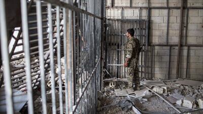 A members of the US-backed Syrian Democratic Forces walk inside a prison built by ISIS fighters in Raqqa, Syria, on October 20, 2017. AP