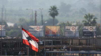 A Lebanese flag flutters in the Lebanese city of Tyre on Thursday amid ongoing cross-border hostilities between Hezbollah and Israeli forces. Reuters